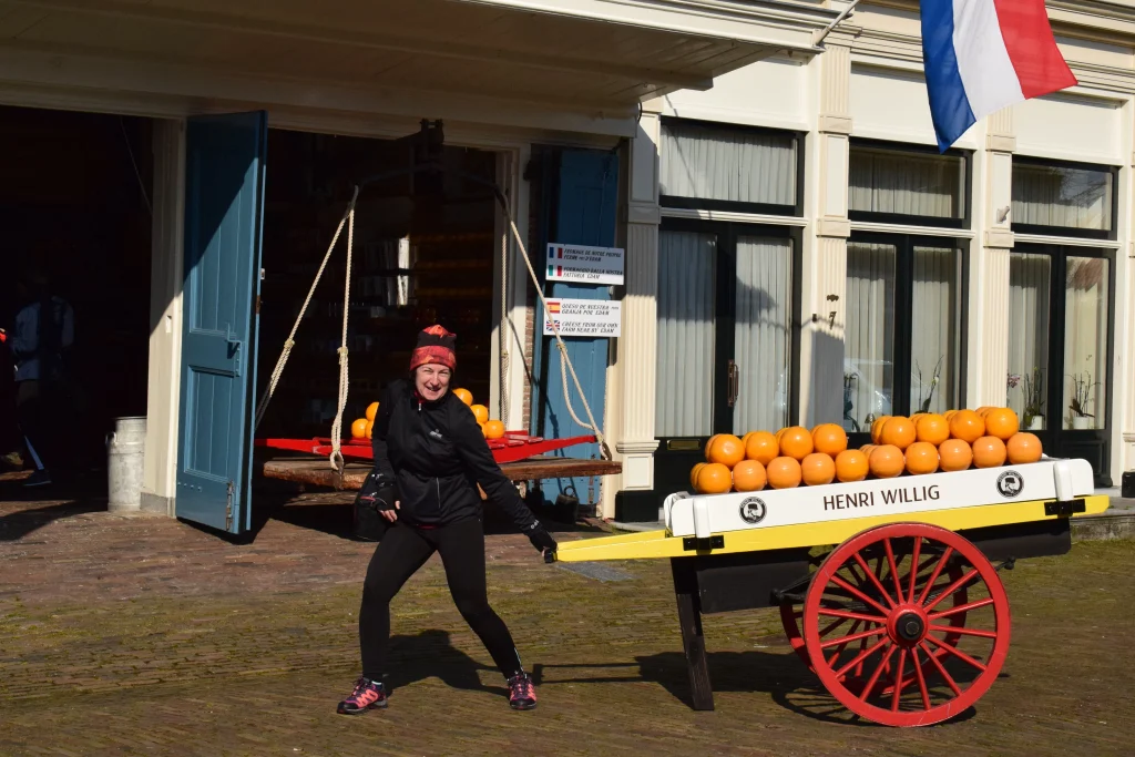 Female traveler visiting a traditional Dutch cheese market in the Netherlands