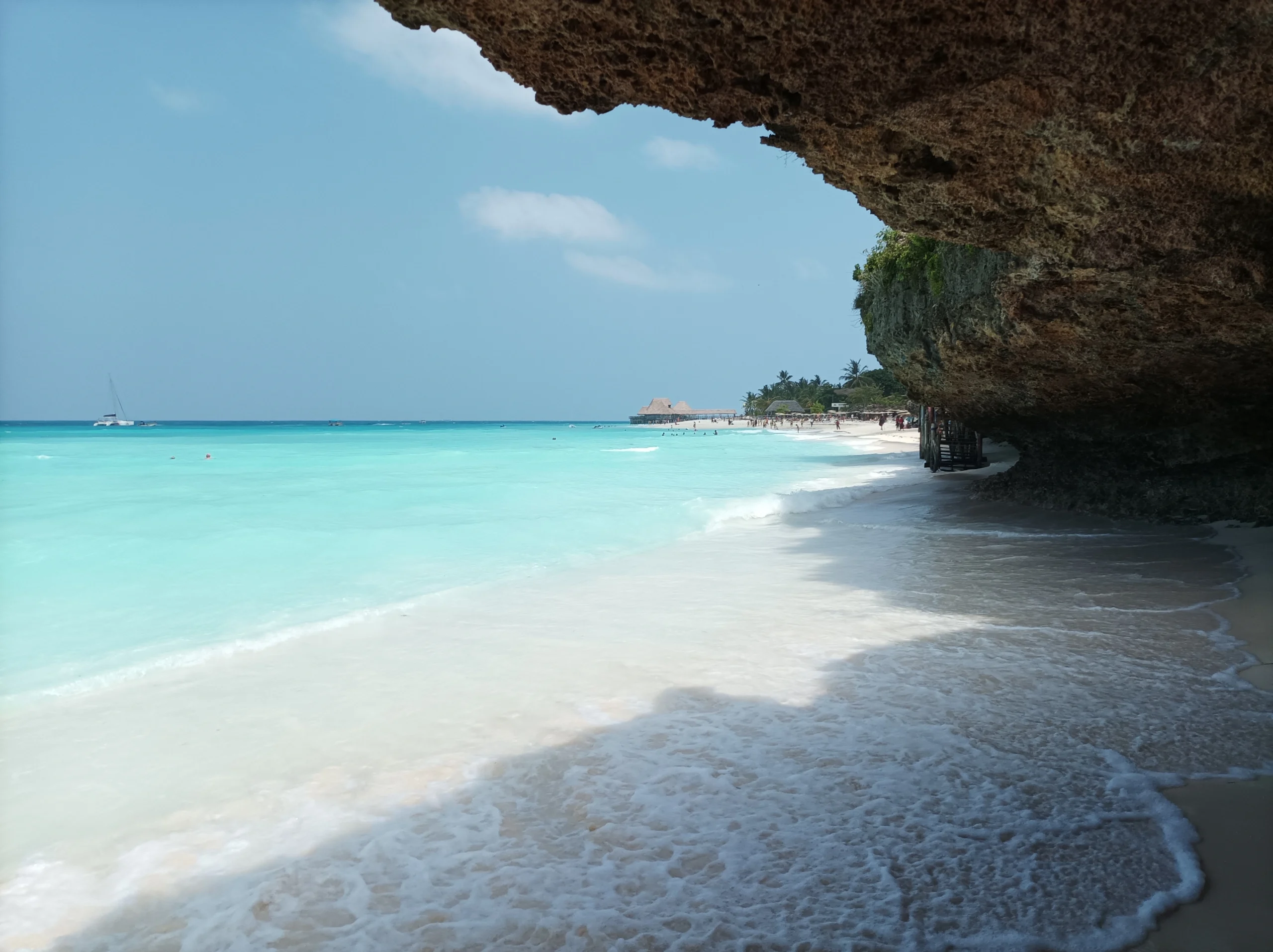 Turquoise water and white sand beach beside a rocky outcrop in Kendwa, Zanzibar