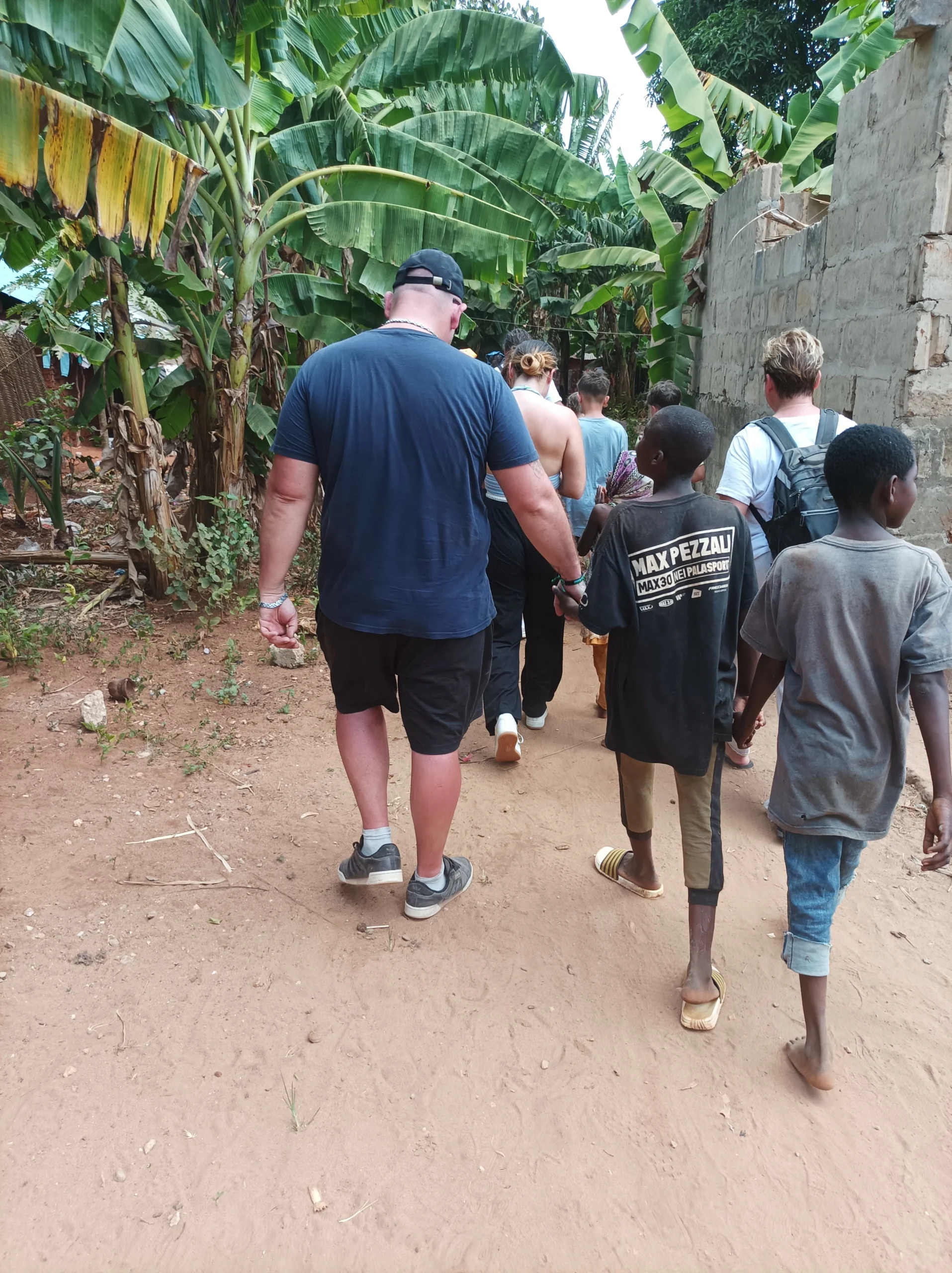 Walking through a local Zanzibar village path with local children
